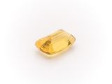 a yellow sapphire stone on a white background