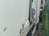 a white truck that is parked next to a chain link fence