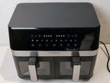 an image of a black and silver toaster on a counter