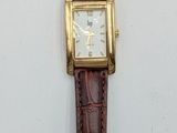 an image of a watch on a white surface with a brown strap