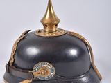 an old helmet with a golden crown on top of it