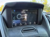 a picture of a car ' s dashboard with a display on it