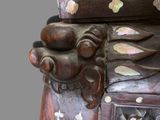 a close up of a carved wooden object with flowers on it