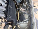 a car engine with the hood open on the street