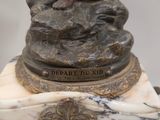 a statue of a woman on a horse on a marble base
