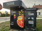 a person taking a picture of a box with a pizza on it
