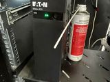 a black shelf with a can of fire extinguisor on top of it