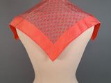 a mannequin torso with a pink scarf on top of it