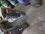 several pairs of ski boots are lined up on the floor