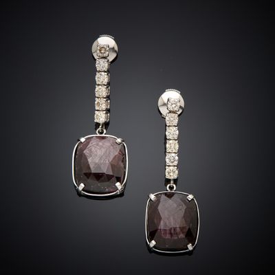 an image of a pair of earrings with diamonds on a black background