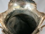 a silver vase with a handle on a white background
