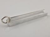 a close up of a metal object on a white surface