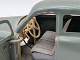 a green toy car with a steering wheel and a steering wheel