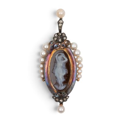 a close up of a necklace with pearls and a picture of a woman