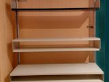 a white shelf with several shelves in it