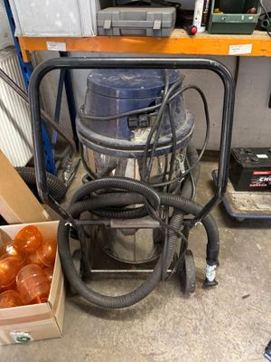 a box of donuts sitting on the floor next to a vacuum