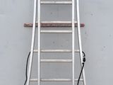 a ladder that is leaning against a wall on the ground