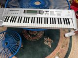 a white keyboard sitting on top of a blue chair