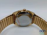 a close up of a gold watch on a white surface