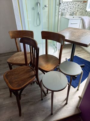 four chairs and a table in a small room