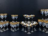 a lot of wine glasses and decanters on the table