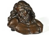a bronze bust of jesus with long hair and a beard