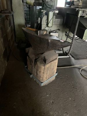 a large piece of metal sitting on top of an anvil