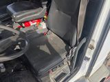 a seat in the back of a truck with a steering wheel