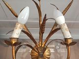 a chandelier with three lights hanging from it ' s ceiling