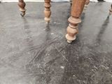 a close up of the legs of a table on the floor