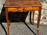 a small wooden table with a drawer on top of it