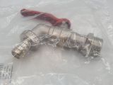 a silver faucet with a red handle in a plastic bag