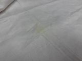 a white sheet of paper with a stain of yellow on it