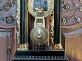 a black and gold clock sitting on a wooden table