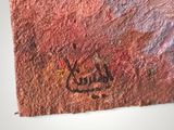 a close up of a piece of art with writing on it