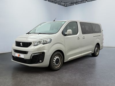 the small white van is parked in a large room