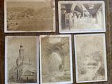 several old photos of a building and a clock tower on a table