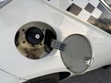 a close up of a white car with a black and white checkerboard on the side of it