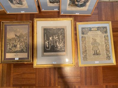 four framed pictures on the wall of a room