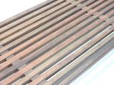 a close up of a wooden bench with slats on it
