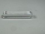 a small glass object on a table with a white background