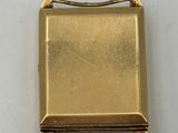an image of a gold buckle on a white surface