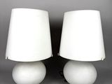 two white lamps with white shades on a gray background