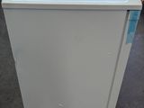 a white refrigerator that is sitting in the middle of a room