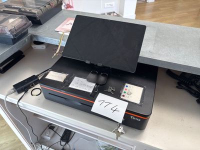a laptop computer sitting on top of a metal table
