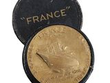 an old gold coin with a picture of a boat on it