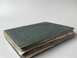 an old book sitting on top of a white table