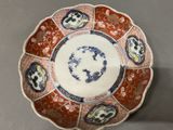 an image of a red and blue plate with a design on it