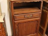 a wooden cabinet with a mirror on top of it
