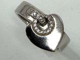 a silver ring with a heart and a letter s on it